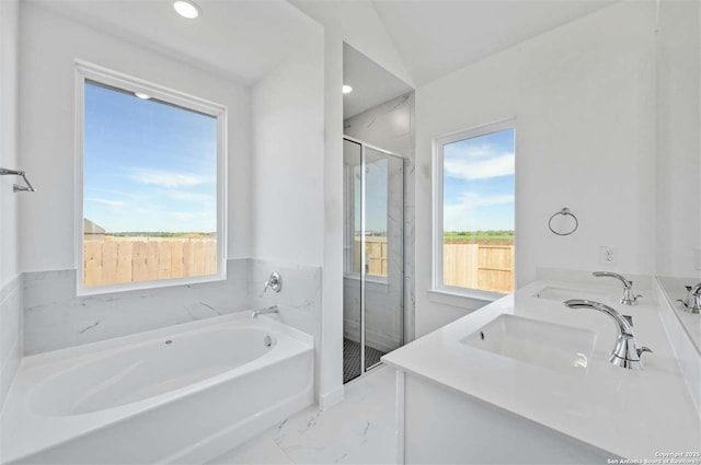 bathroom with vanity, independent shower and bath, and vaulted ceiling