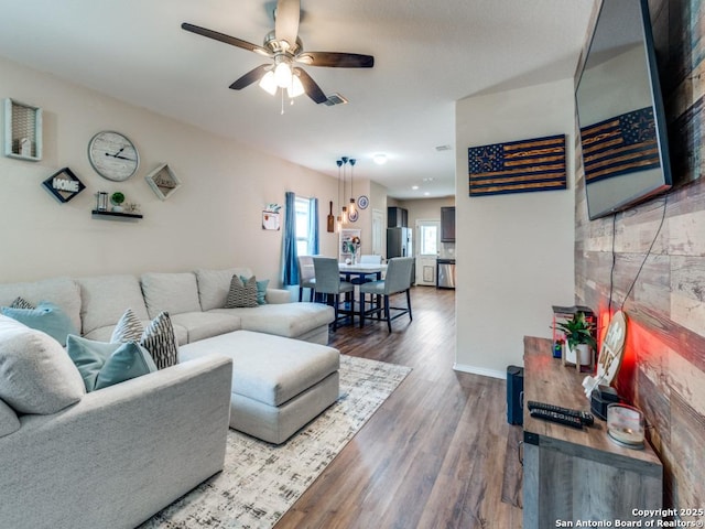 living room featuring ceiling fan and hardwood / wood-style flooring