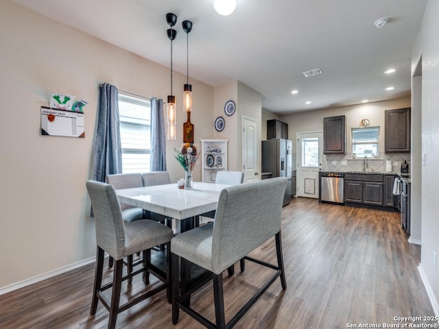 dining area with sink and dark hardwood / wood-style floors