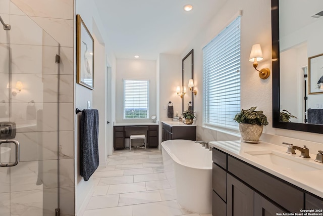 bathroom featuring vanity and shower with separate bathtub