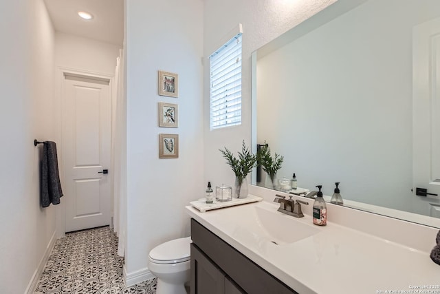 bathroom with tile patterned floors, vanity, and toilet