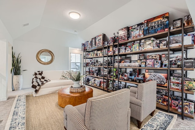 living area featuring light carpet and lofted ceiling