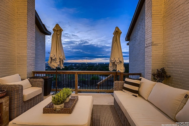 balcony at dusk with an outdoor hangout area