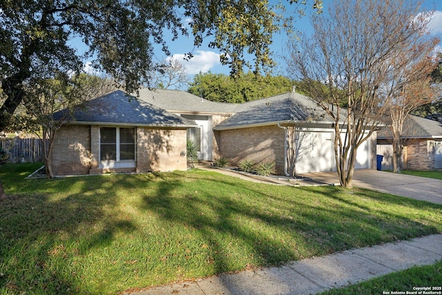 ranch-style house featuring a garage and a front lawn