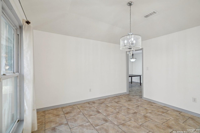 empty room featuring a chandelier