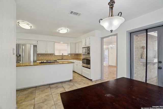 kitchen featuring stone counters, sink, appliances with stainless steel finishes, tasteful backsplash, and white cabinetry