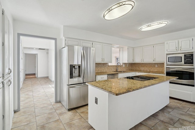 kitchen with white cabinets, a center island, sink, and stainless steel appliances