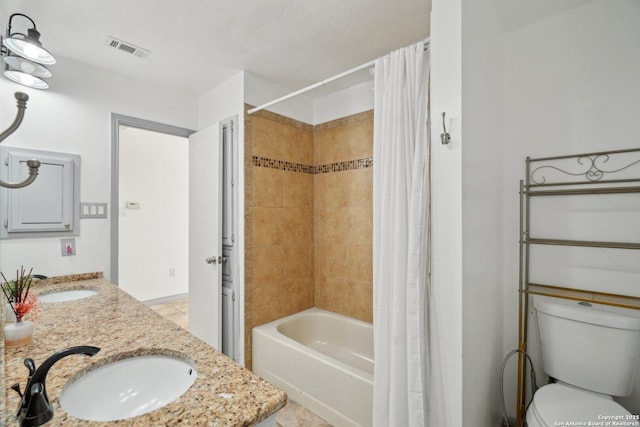 full bathroom featuring tile patterned flooring, shower / bath combination with curtain, toilet, and sink