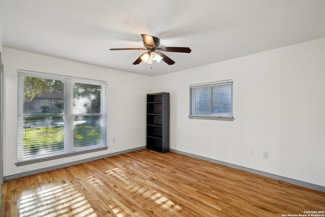 empty room featuring ceiling fan and light hardwood / wood-style floors