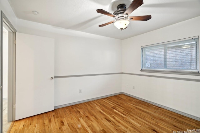 spare room featuring light hardwood / wood-style floors and ceiling fan