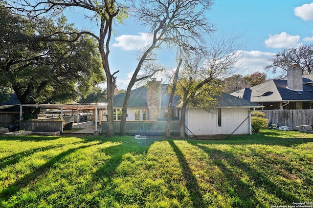 rear view of property with a lawn