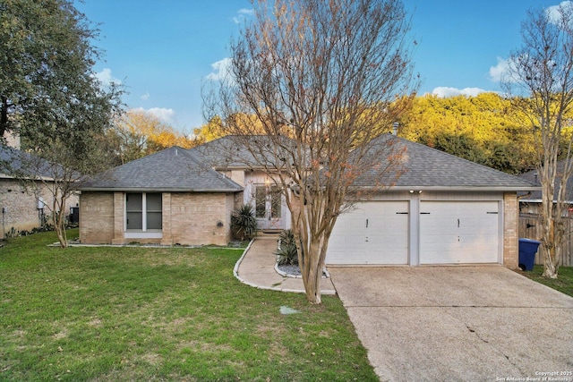 single story home with a garage and a front lawn