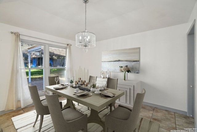 tiled dining room with a notable chandelier