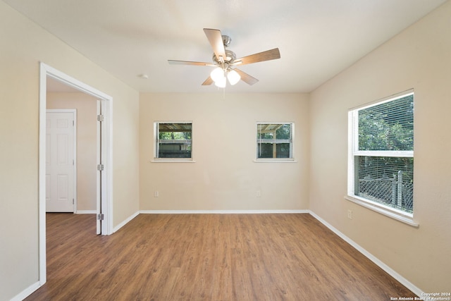 empty room with ceiling fan and hardwood / wood-style flooring