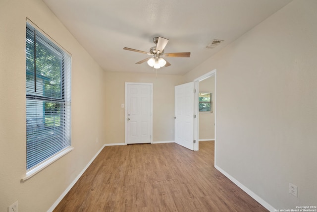 spare room featuring light wood-type flooring and ceiling fan