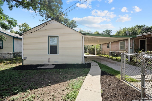 view of side of home with a carport