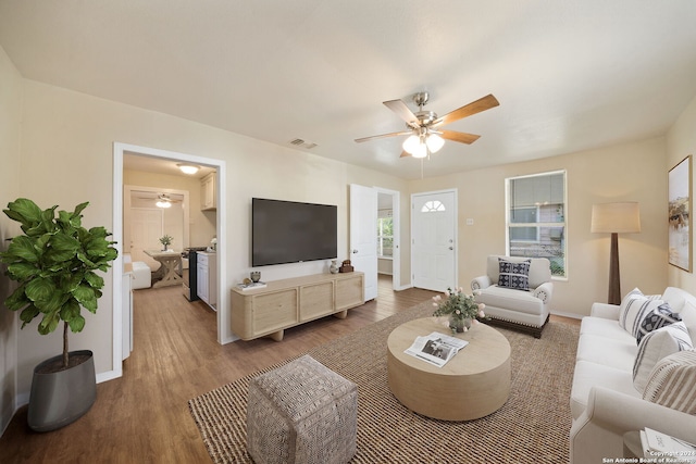 living room featuring hardwood / wood-style floors and ceiling fan