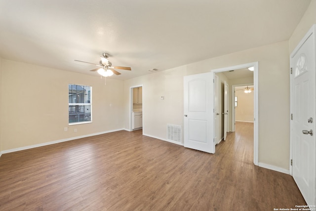 unfurnished room with ceiling fan and wood-type flooring