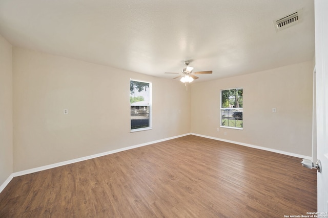 spare room featuring hardwood / wood-style flooring and ceiling fan