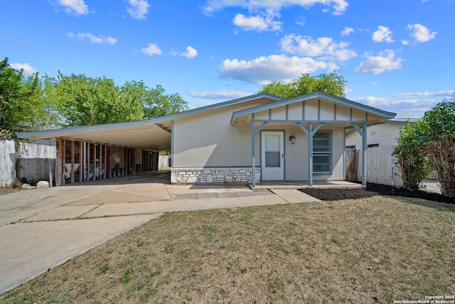 view of front facade with a front yard and a carport