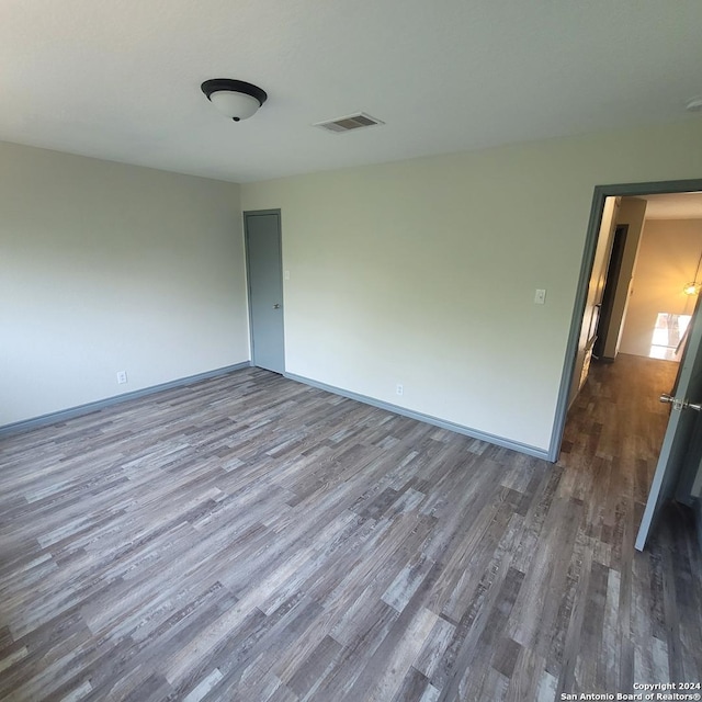 spare room with dark wood-type flooring