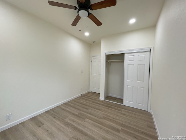 unfurnished bedroom featuring light hardwood / wood-style floors, a closet, and ceiling fan