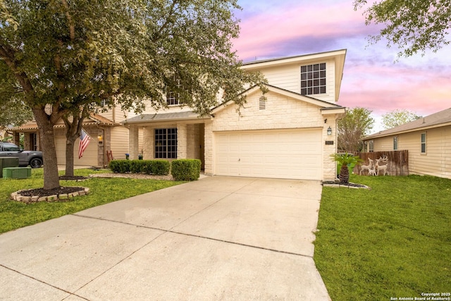 front facade featuring a garage and a yard