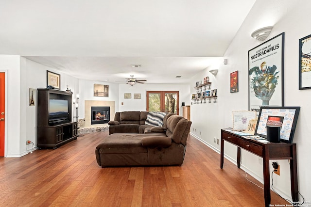 living room with hardwood / wood-style floors and ceiling fan