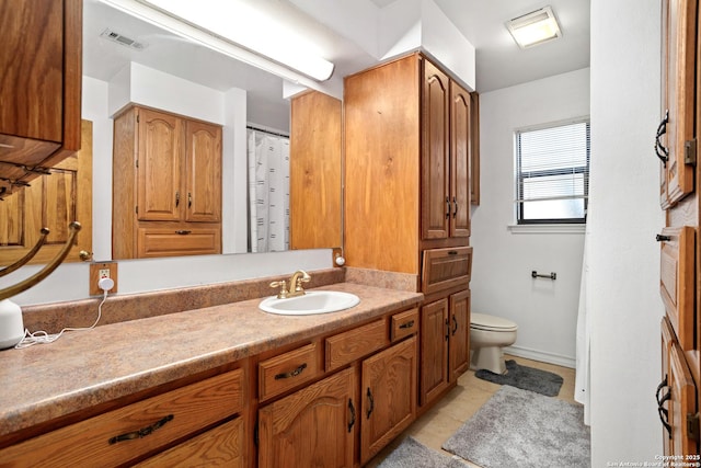 bathroom with tile patterned floors, vanity, and toilet