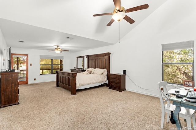 carpeted bedroom with ceiling fan and vaulted ceiling