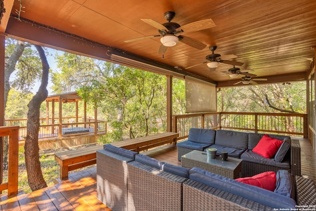 wooden deck with ceiling fan and an outdoor hangout area