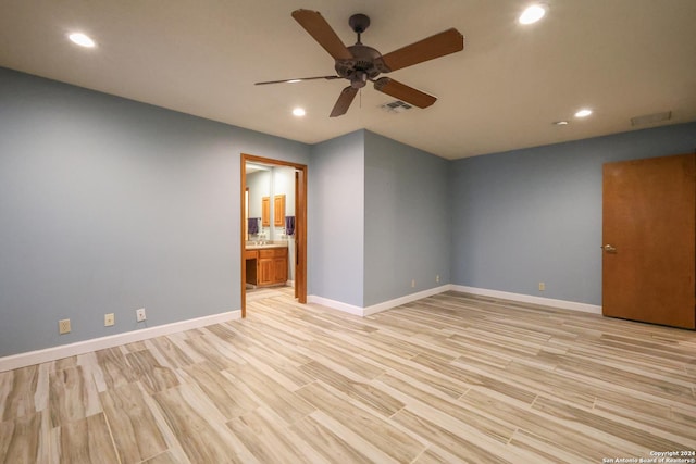 empty room featuring ceiling fan and light hardwood / wood-style floors