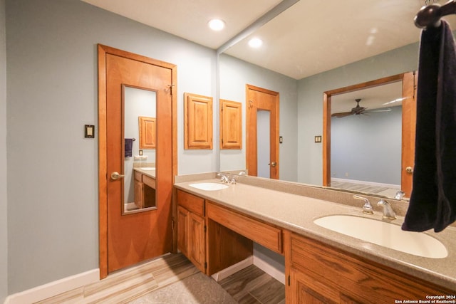 bathroom featuring ceiling fan, vanity, and wood-type flooring