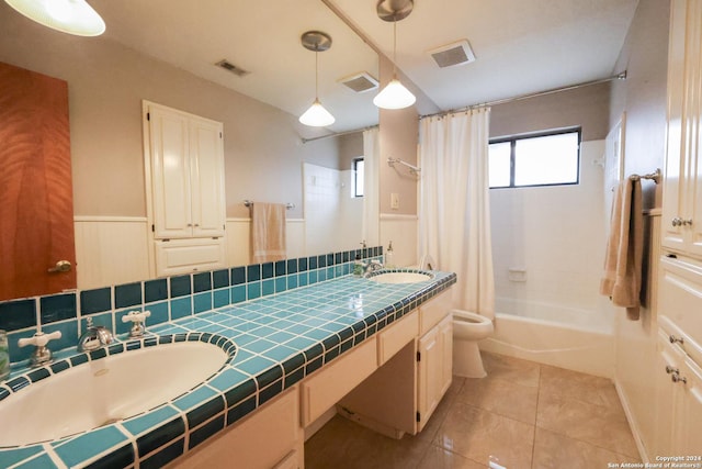 full bathroom with tile patterned floors, shower / bath combo, toilet, and vanity