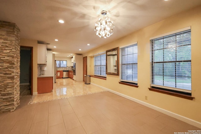 interior space featuring plenty of natural light and an inviting chandelier