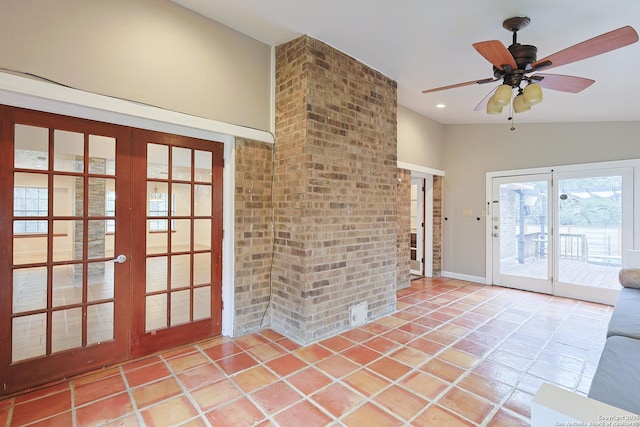 interior space with tile patterned floors, ceiling fan, and lofted ceiling