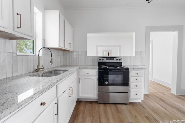 kitchen featuring decorative backsplash, stainless steel electric range oven, sink, and white cabinets