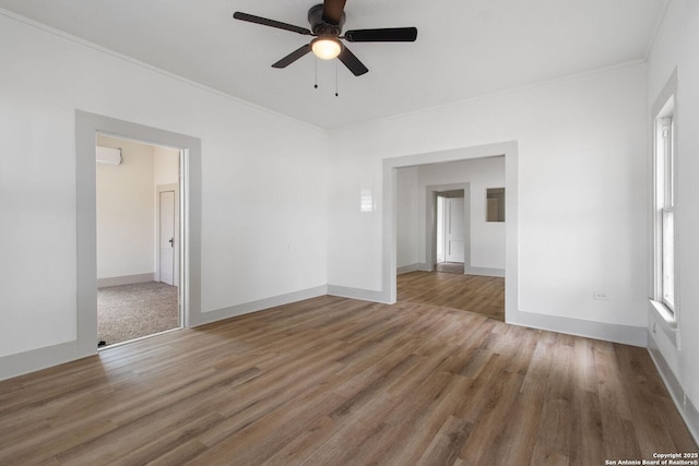 unfurnished room with hardwood / wood-style floors, ceiling fan, and crown molding