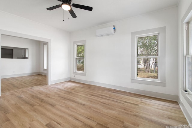 unfurnished room featuring ceiling fan, light hardwood / wood-style floors, and an AC wall unit