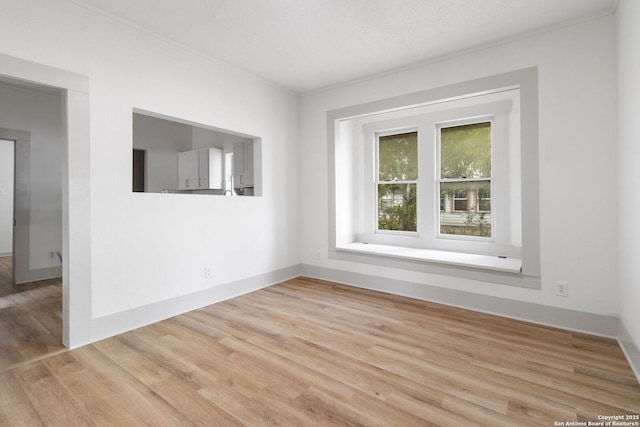 spare room with light hardwood / wood-style flooring