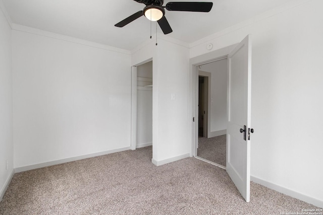 unfurnished bedroom with light carpet, a closet, ceiling fan, and crown molding