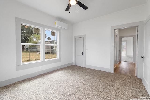 carpeted empty room with a wall mounted AC and ceiling fan