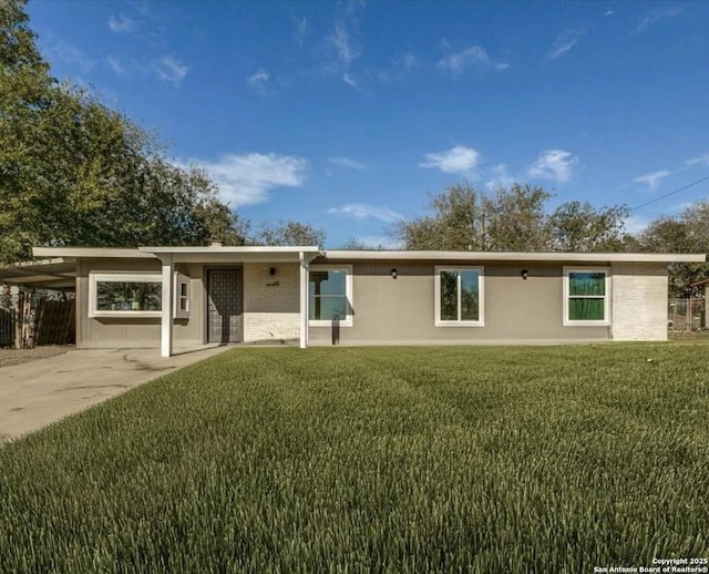 single story home with a front lawn and a carport