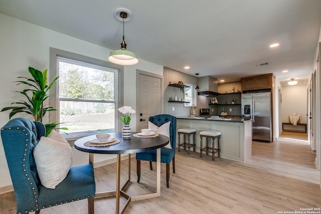 dining area with light hardwood / wood-style flooring and sink