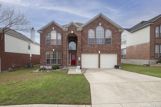 front facade featuring central air condition unit, a front lawn, and a garage