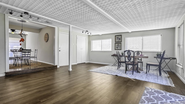 dining area with ceiling fan, rail lighting, and dark wood-type flooring