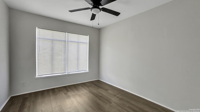 unfurnished room featuring ceiling fan and dark wood-type flooring