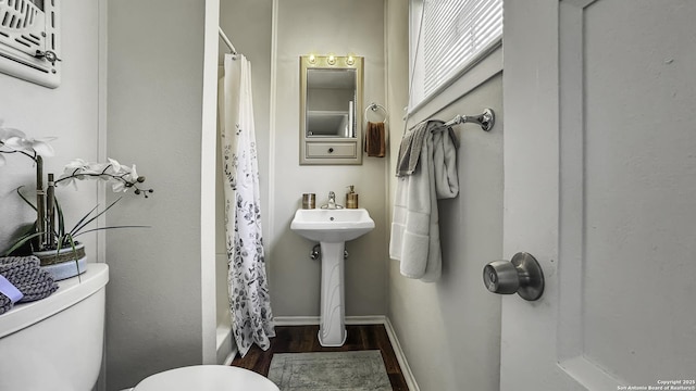 bathroom with wood-type flooring and toilet