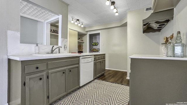 kitchen featuring gray cabinets, sink, and white dishwasher