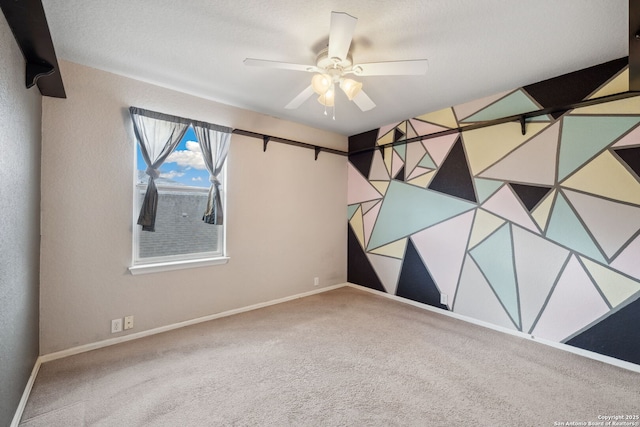 spare room with carpet flooring and ceiling fan